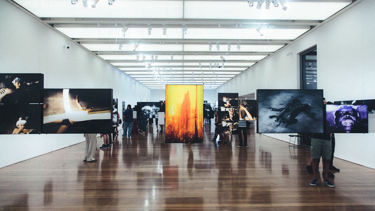 Artist working at an easel in a bright studio space