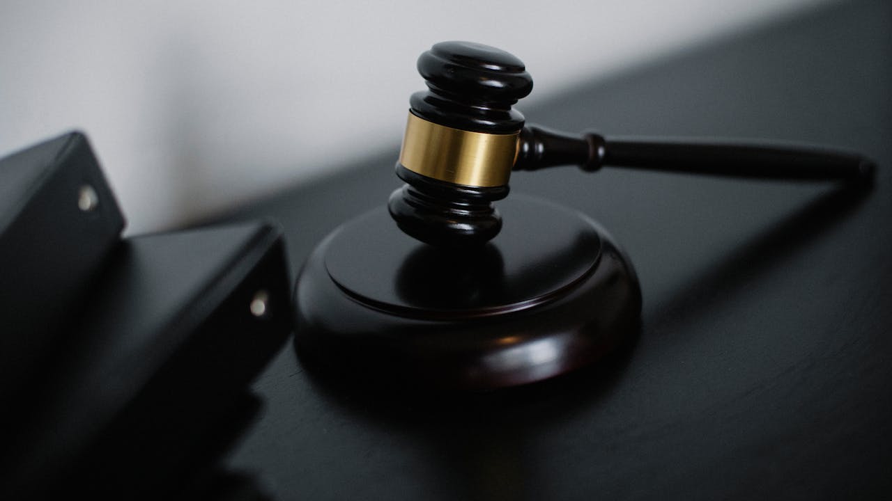 Professional attorney working at desk with leather-bound books