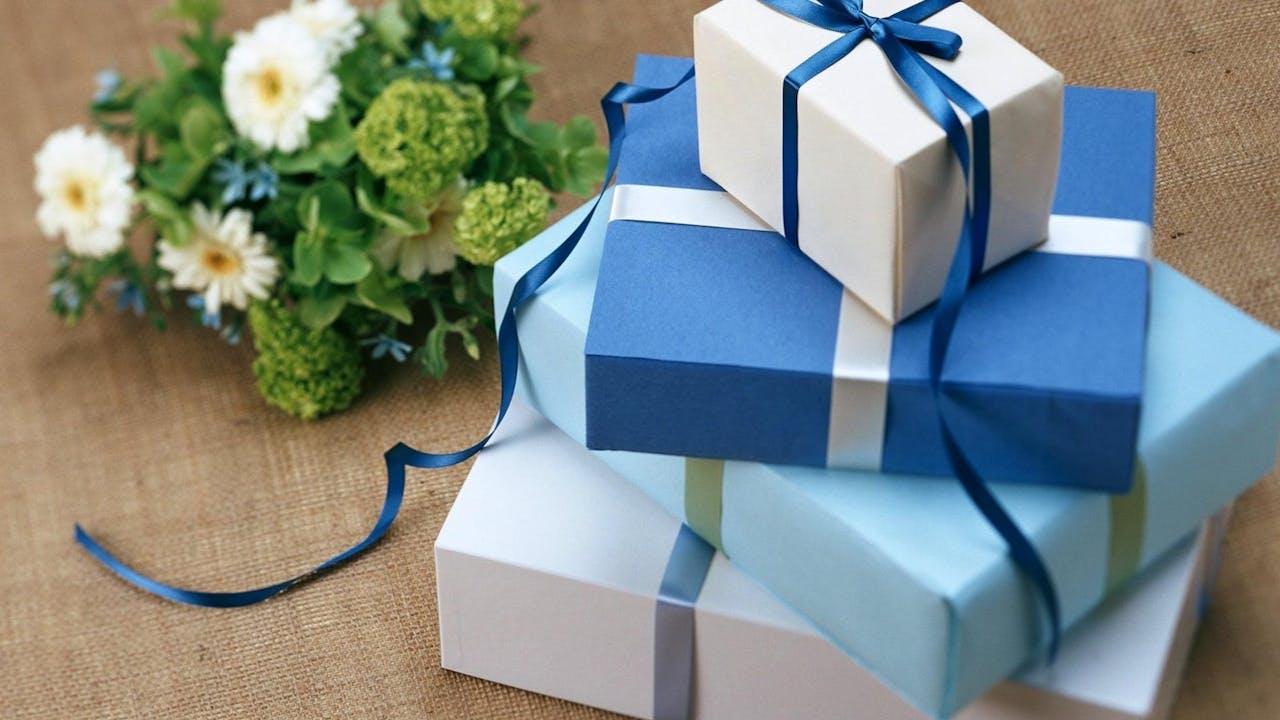 Curated gift box with chocolates, candles, and wrapped presents