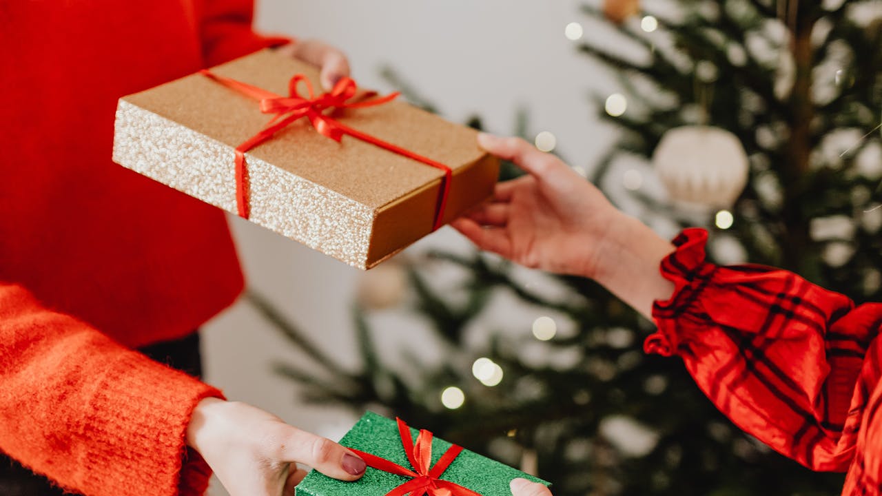 Person opening a Christmas art gift