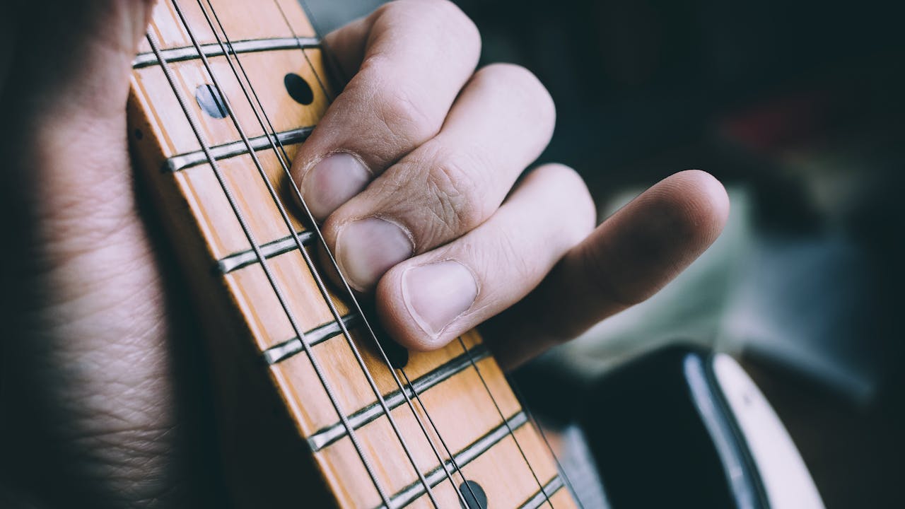 Guitarist playing acoustic guitar in a cozy room