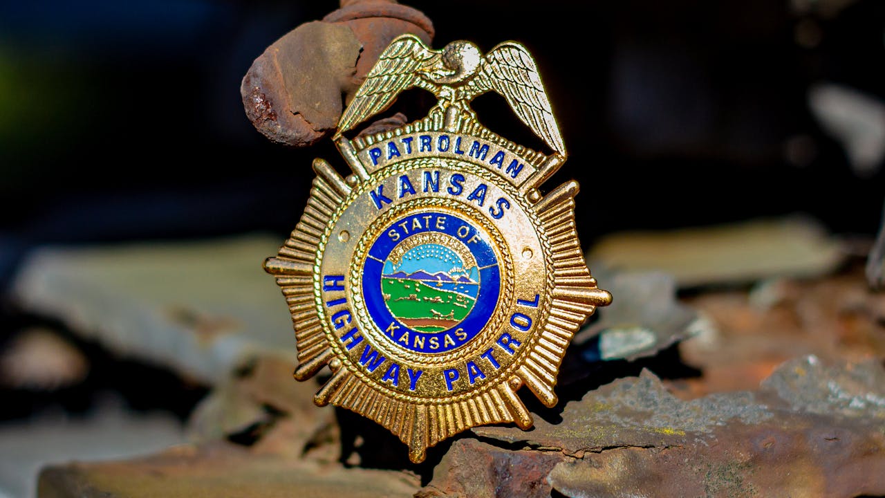 Close-up of a golden police badge resting on a surface