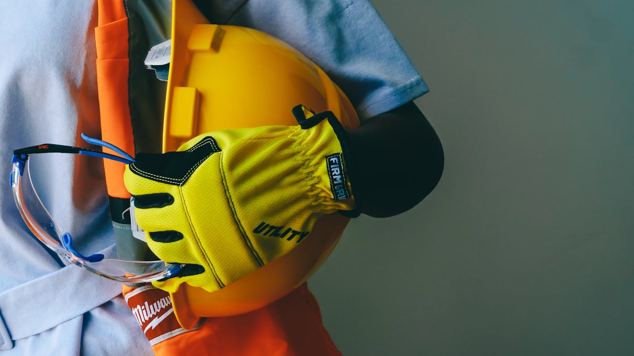 Worker boots, gloves, and hard hat representing a lifetime of lineman work