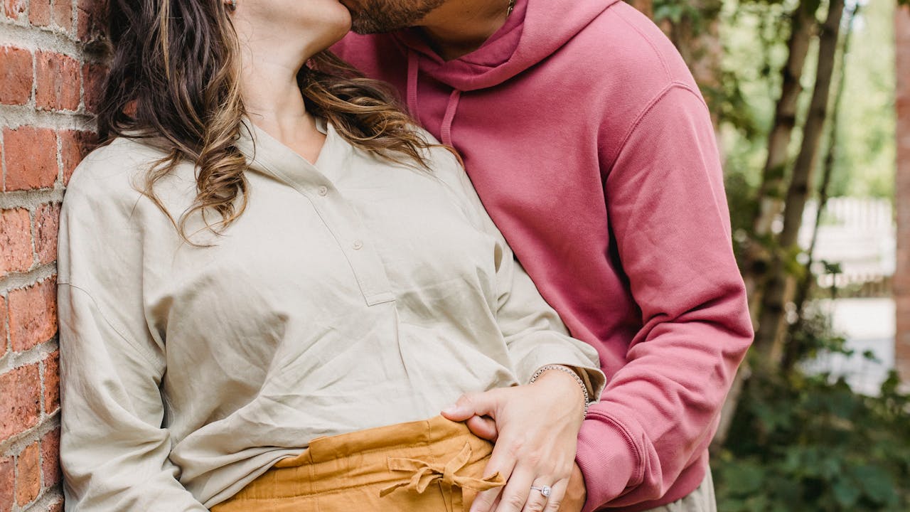 Romantic pregnant couple sharing a tender moment outdoors